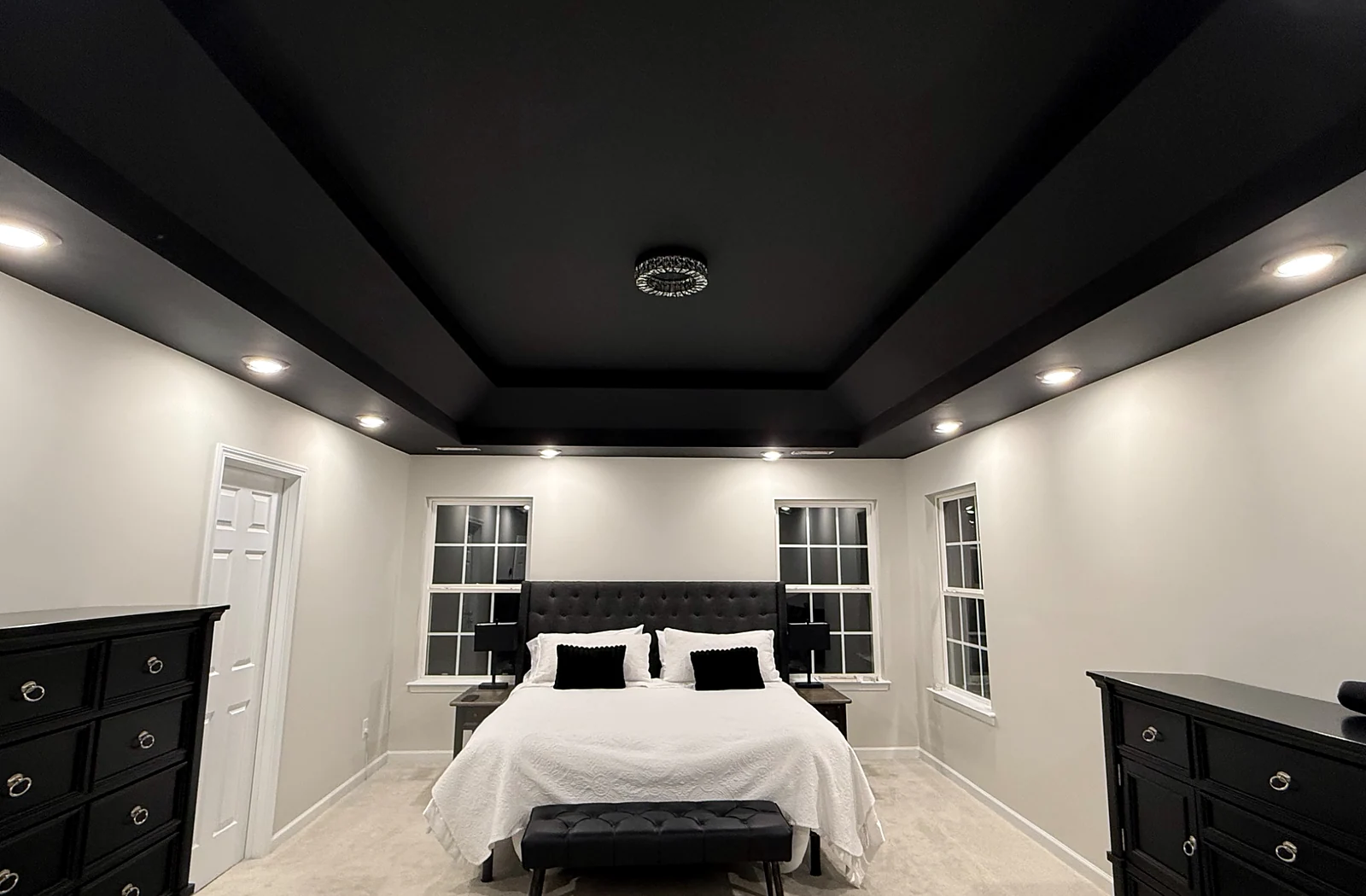 Completed bedroom renovation with detailed tray ceiling and professional painting